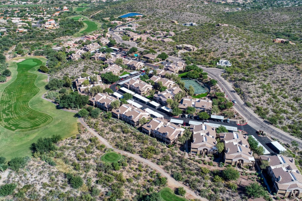 Overhead drone view of community surrounded by lush landscaping and golf course at Starrview at Starr Pass in Tucson, AZ