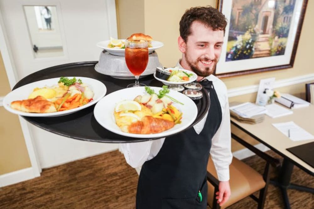 Server with meals at Harmony at Kent in Dover, Delaware
