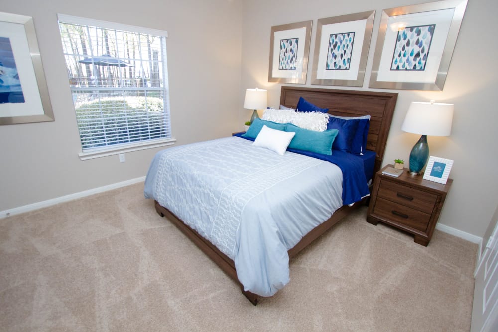 Bedroom with soft carpeting and natural light at Eagle Crest Apartments in Humble, Texas
