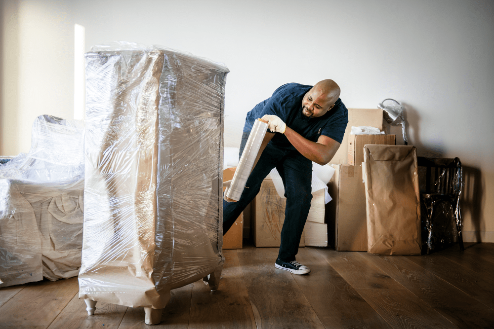 A man unwrapping a sealed box at A-American Self Storage in Dacono, Colorado