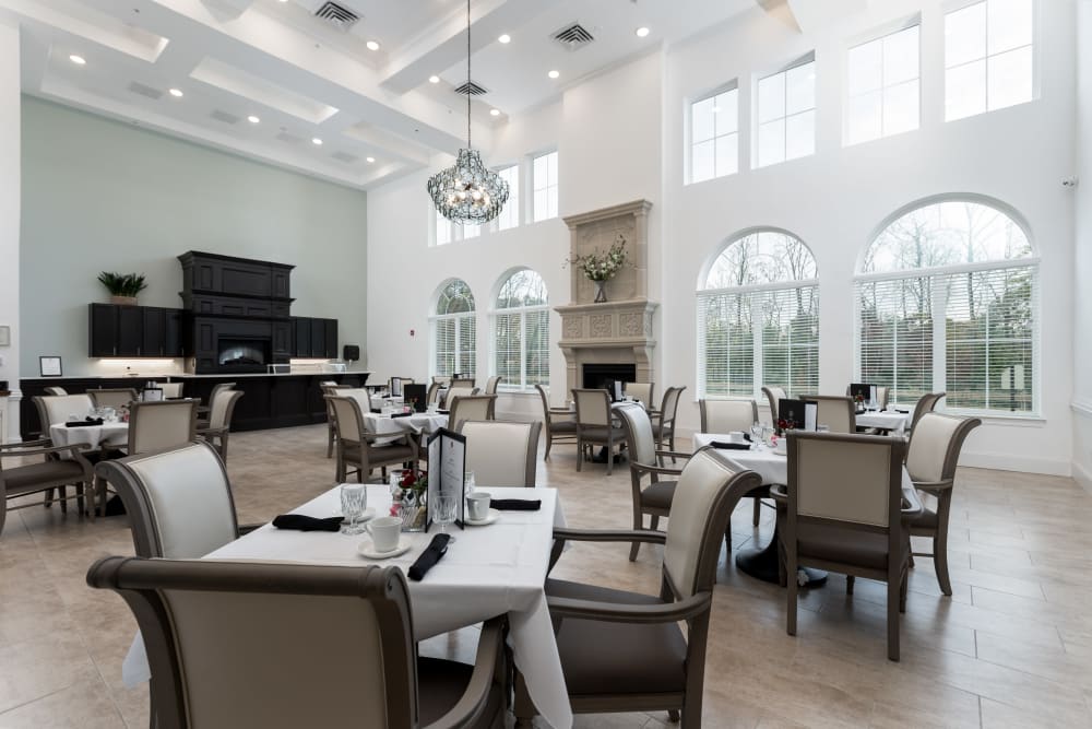 Dining hall with a fireplace and wine bar at The Blake at Charlottesville in Charlottesville, Virginia
