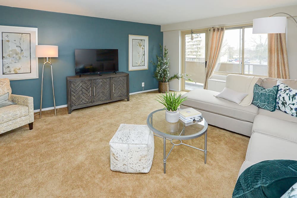 Model living room with an accent wall at Towers of Windsor Park Apartment Homes in Cherry Hill, New Jersey