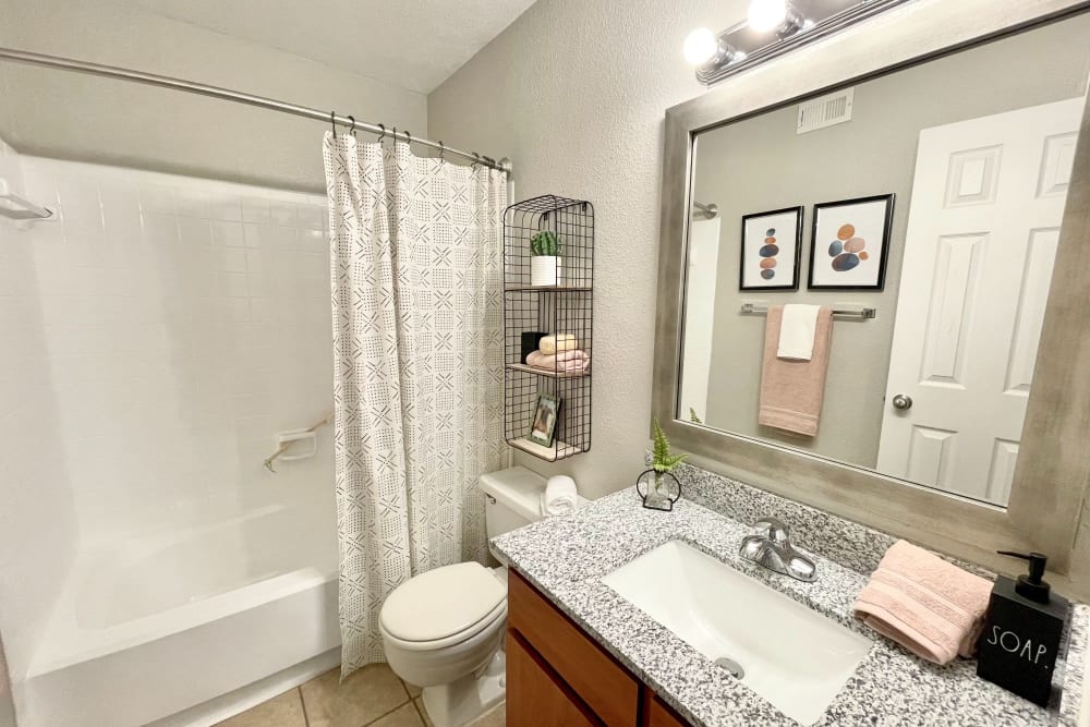 Bathroom with granite countertops at The Abbey at Energy Corridor in Houston, Texas