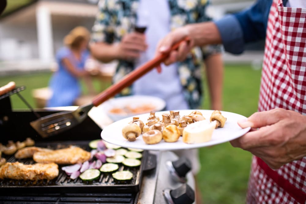 Resident barbequing food at Arasan Apartments in Shakopee, Minnesota