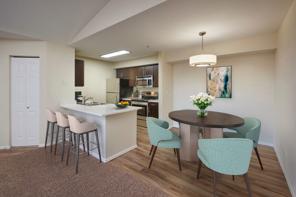 Dining room with wood-style flooring at The Crossings at Bear Creek Apartments in Lakewood, Colorado