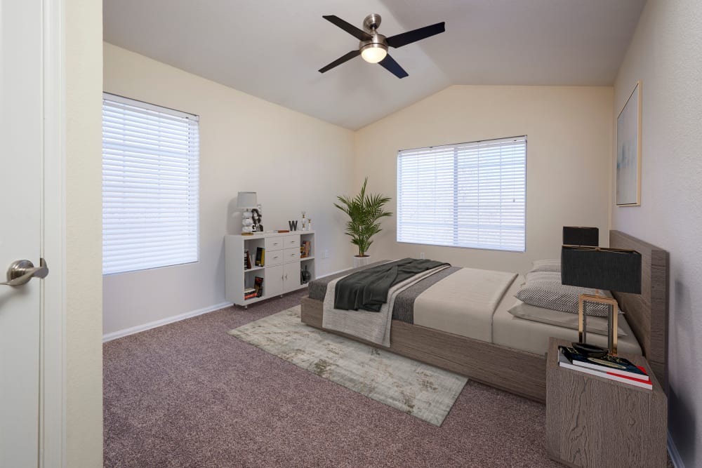 Master bedroom with an attached bathroom at The Crossings at Bear Creek Apartments in Lakewood, Colorado