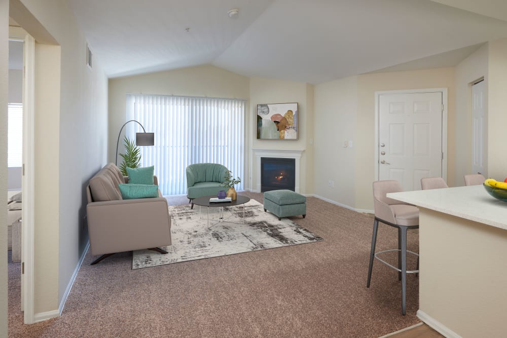 A living room complete with patio access at The Crossings at Bear Creek Apartments in Lakewood, Colorado