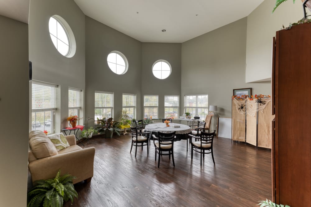 Large lounge with windows letting lots of sunlight in at Addington Place of Shiloh in Shiloh, Illinois