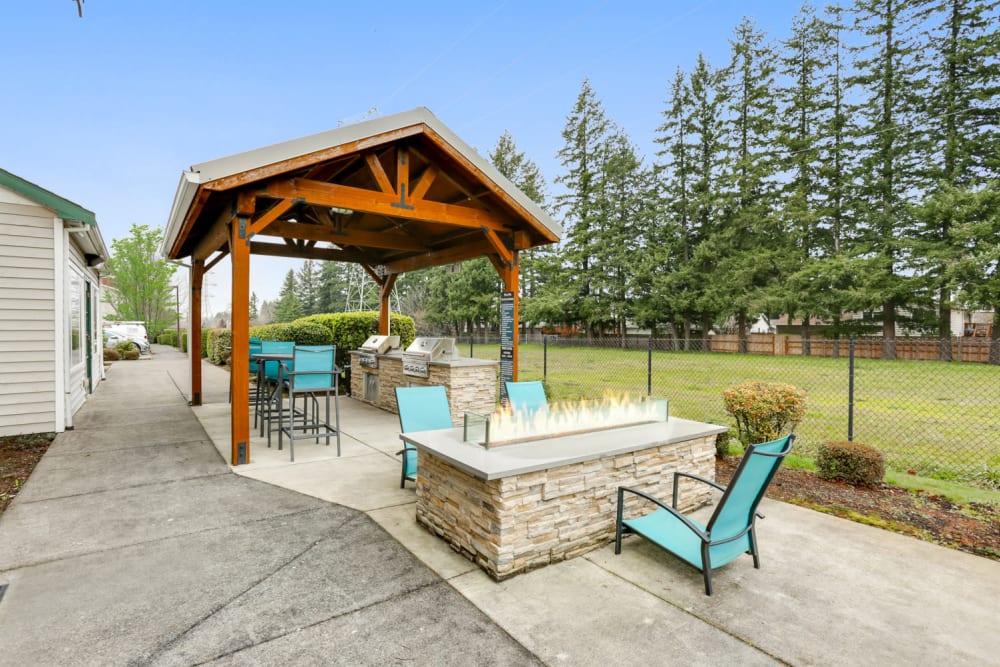 Lounge area with a fire pit at The Landings at Morrison Apartments in Gresham, Oregon