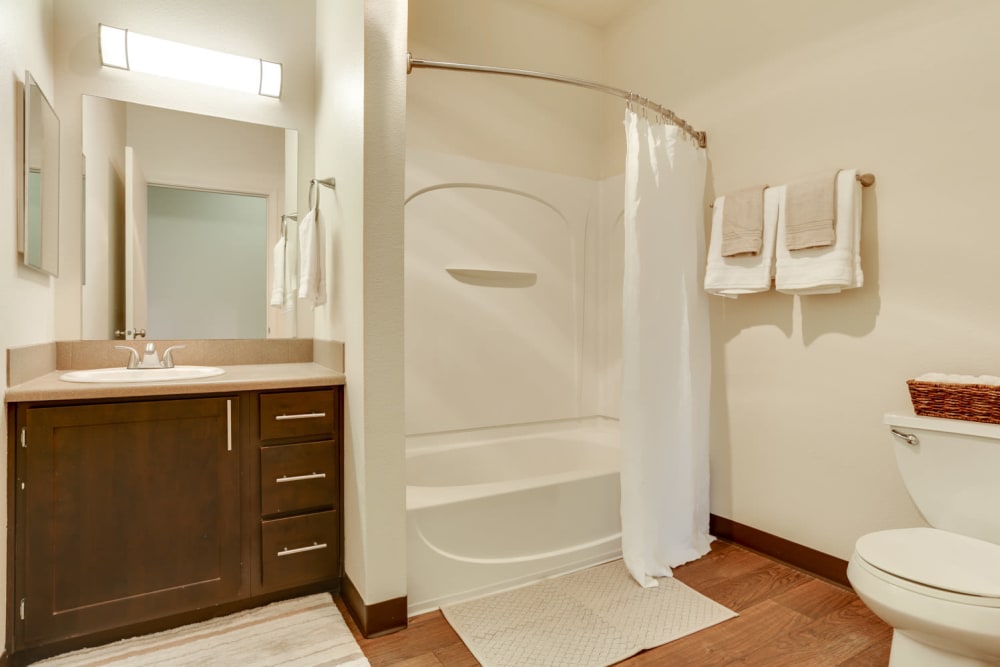 Renovated Brown Cabinetry bathroom at The Landings at Morrison Apartments in Gresham, Oregon