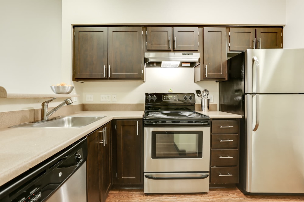 Kitchen with espresso cabinets at The Landings at Morrison Apartments in Gresham, Oregon