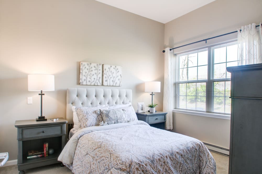 Model apartment bedroom with bed, nightstands, and dresser at The Pinnacle in Plymouth Meeting, Pennsylvania