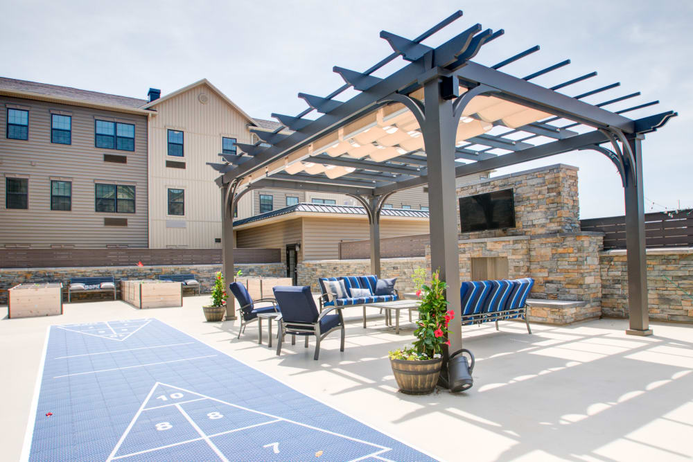 Shade awning with comfortable couch seating on outdoor patio at The Pinnacle in Plymouth Meeting, Pennsylvania