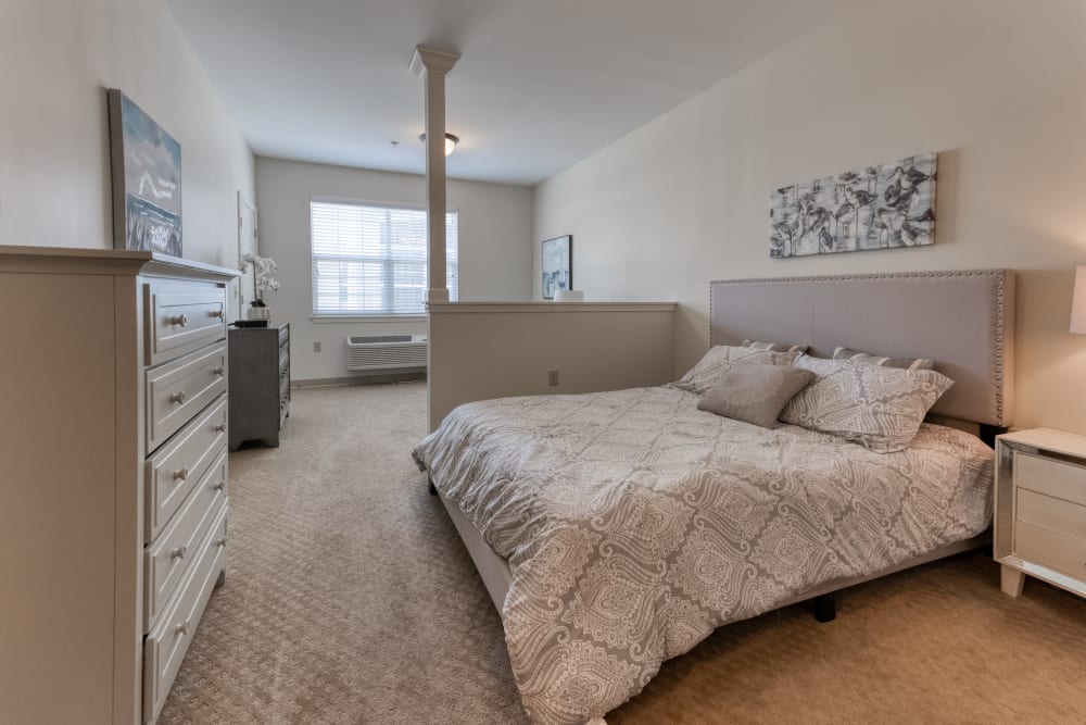 Bed in a senior apartment at Addington Place of Prairie Village in Prairie Village, Kansas