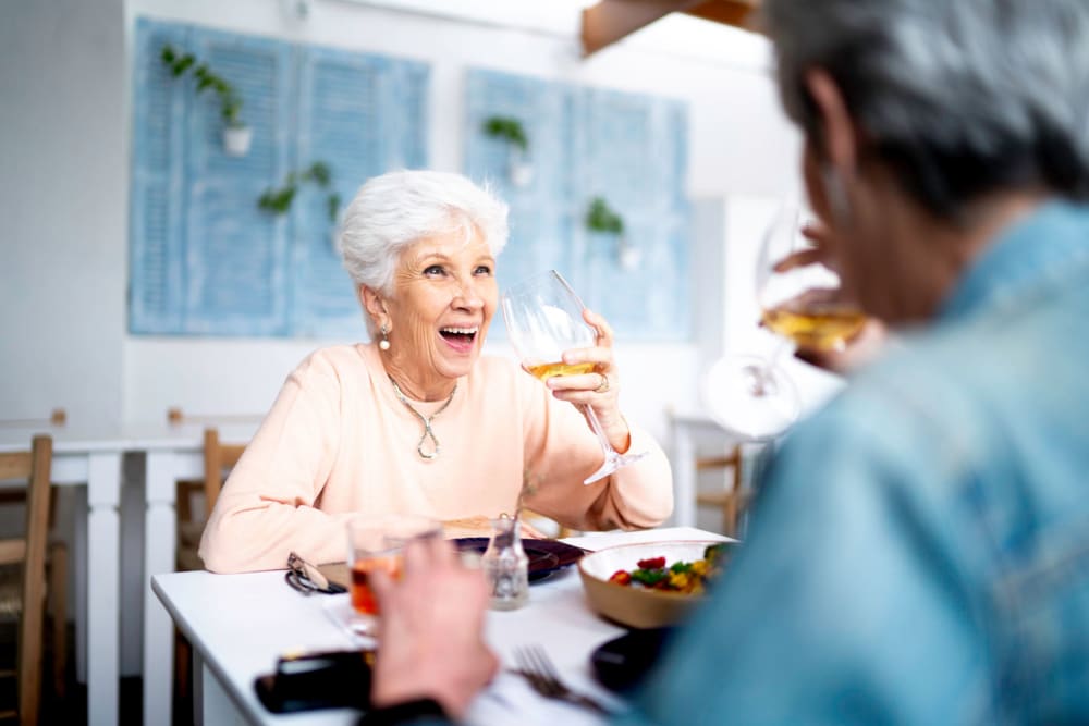 Resident couple enjoying a meal in the bistro at Belmare Senior Living in Oakdale, California