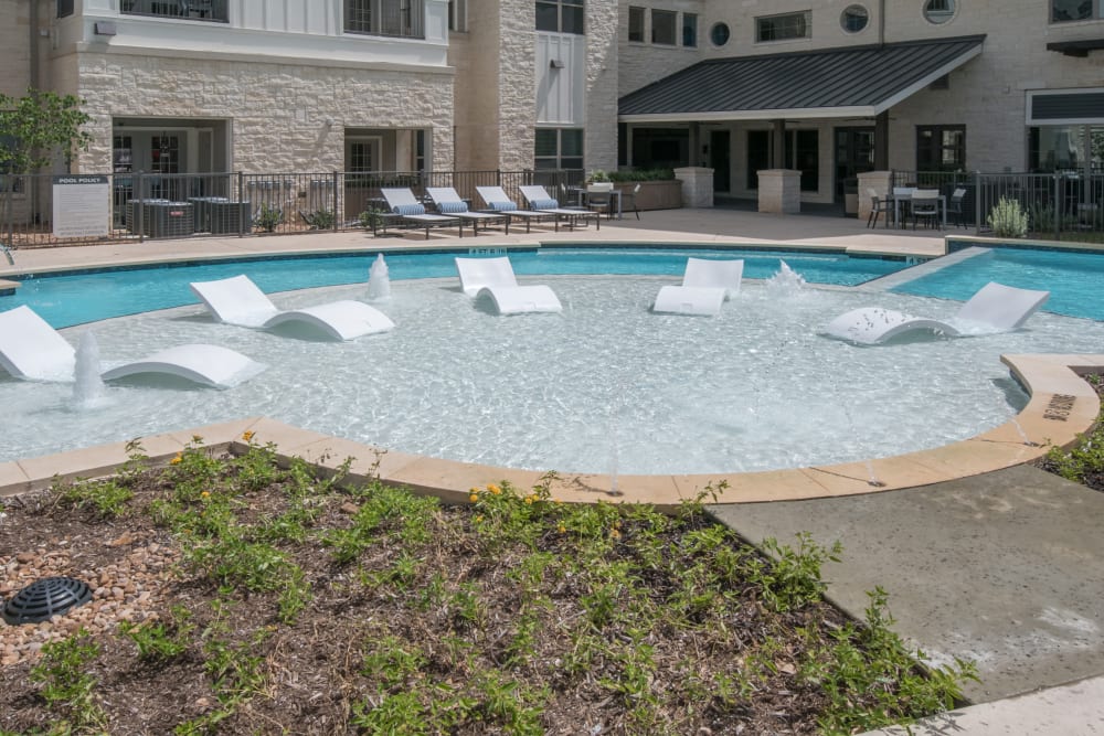 Swimming pool with lounging chairs at Marquis Dominion in San Antonio, Texas