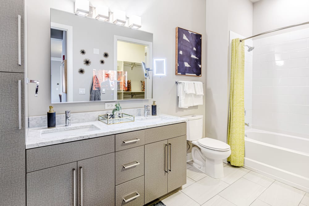 Upscale bathroom with double sinks at The Barton | Apartments in Clayton, Missouri