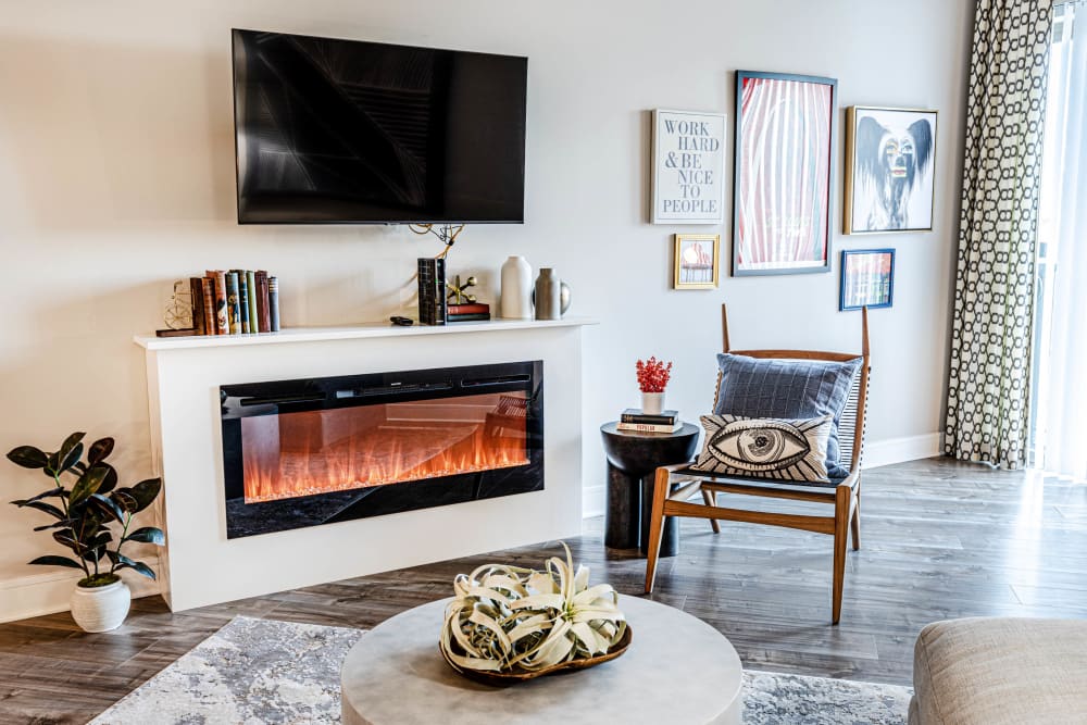 TV and a built-in fireplace in a living room at The Barton | Apartments in Clayton, Missouri
