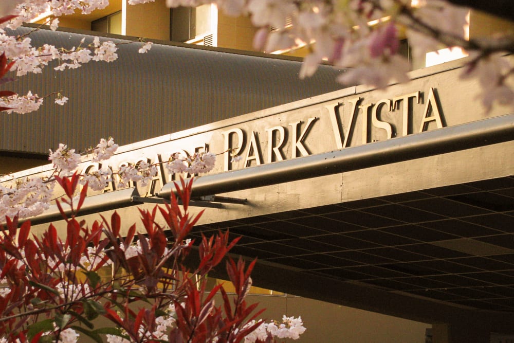 Marquis surrounded by blooming cherry blossoms at Cascade Park Vista Assisted Living in Tacoma, Washington