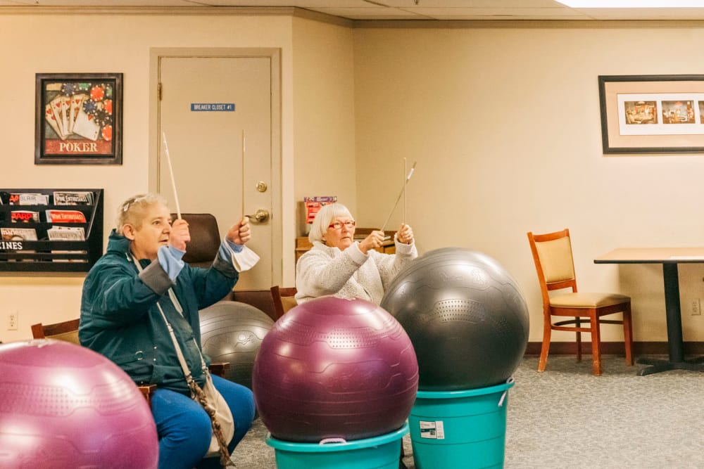 Residents in a drumming activity at Cascade Park Vista Assisted Living in Tacoma, Washington