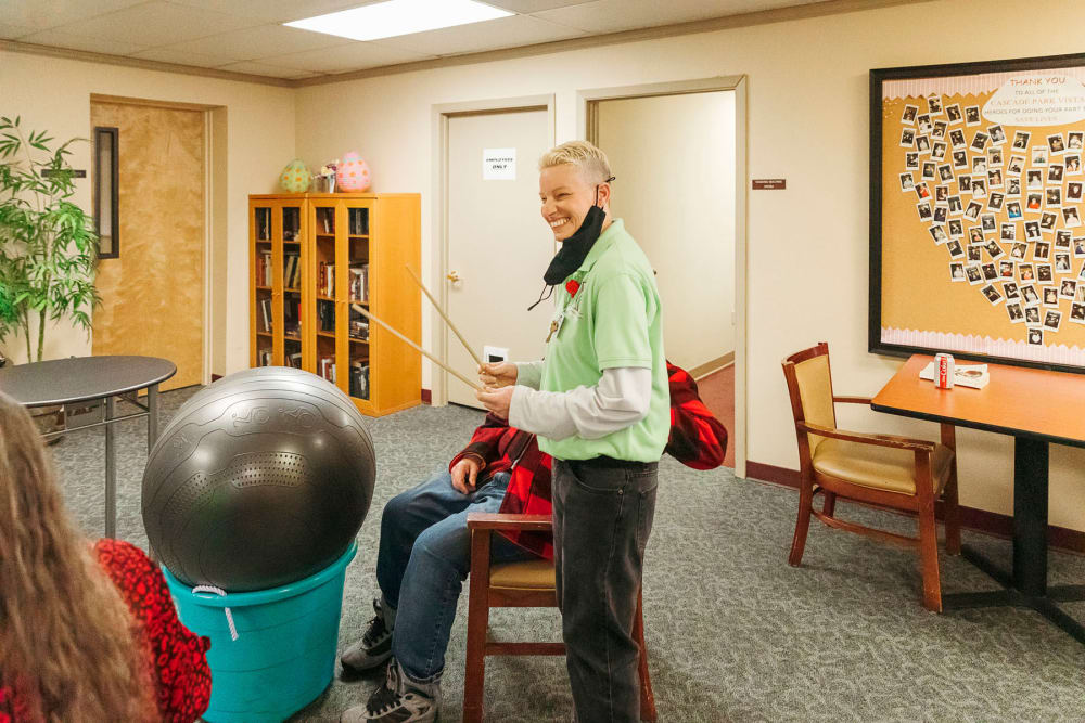 Activities director getting a makeshift drumming session going for residents at Cascade Park Vista Assisted Living in Tacoma, Washington