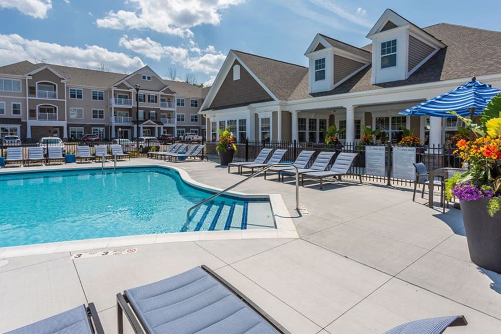 Beautiful pool and lounge chairs at Winding Creek Apartments in Webster, New York