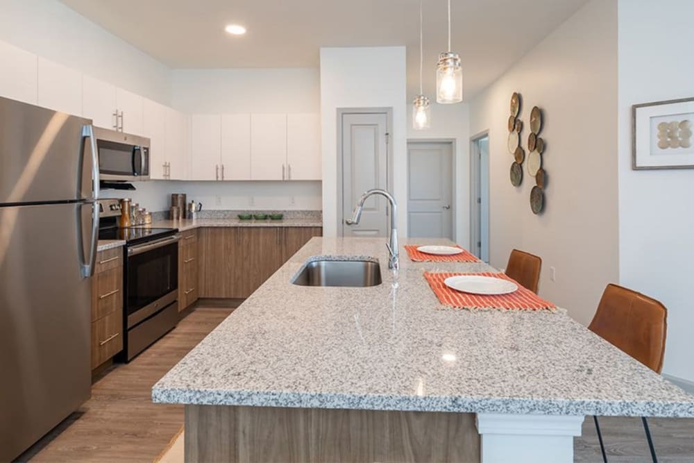 Kitchen with modern details at Winding Creek Apartments in Webster, New York
