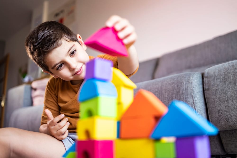 Child playing with some colorful building blocks at The Mayfair Apartment Homes in New Orleans, Louisiana