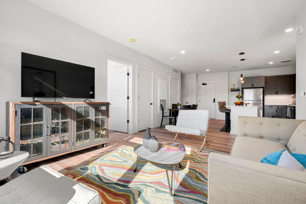 Well-furnished living area in an open-concept model apartment at Anden in Weymouth, Massachusetts