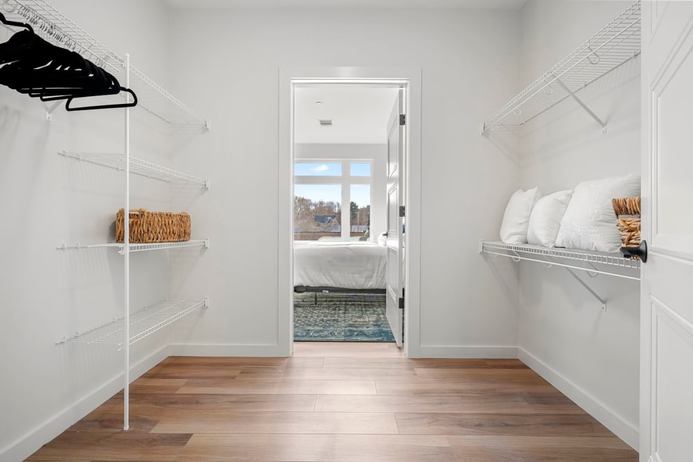 Hardwood-style flooring in a model apartment's spacious walk-in closet at Anden in Weymouth, Massachusetts