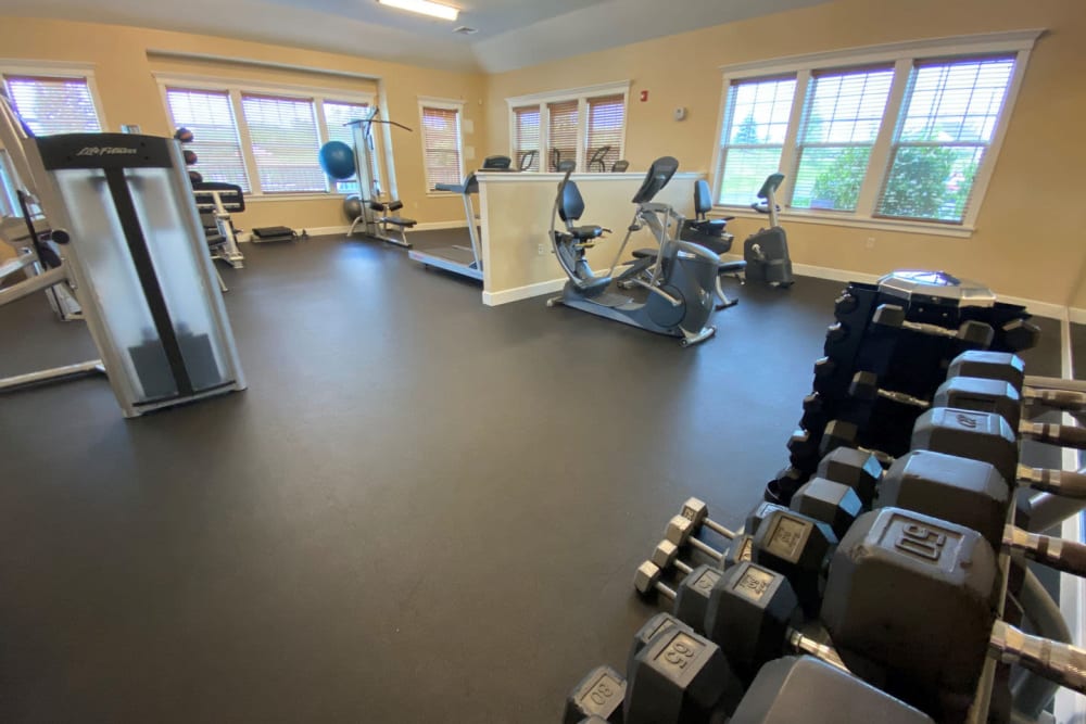 Onsite fitness center with plenty of free weights and exercise machines at Rivers Pointe Apartments in Liverpool, New York