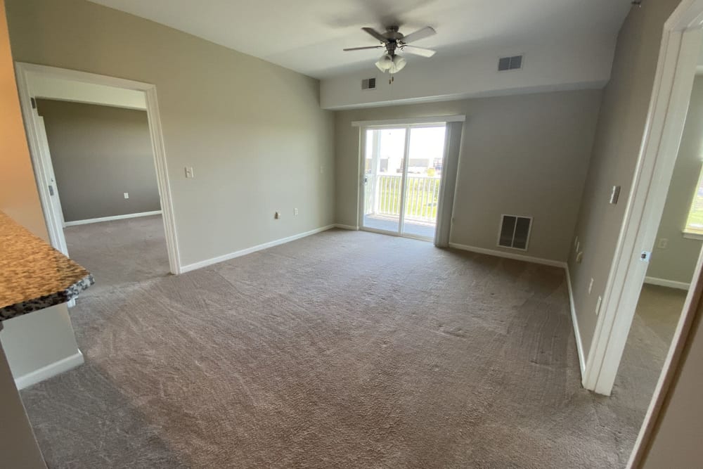 Plush carpeting and a ceiling fan in a model home at Rivers Pointe Apartments in Liverpool, New York