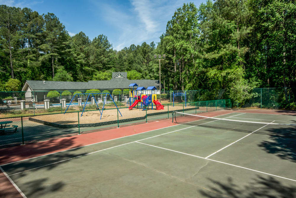 Full sized tennis court next to the playgroud at Arbor Crossing Apartments in Lithonia, Georgia