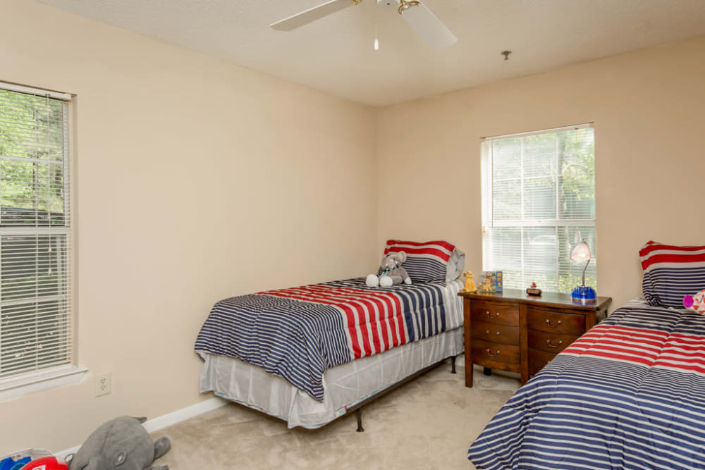 Two twin beds in a children's room at Arbor Crossing Apartments in Lithonia, Georgia