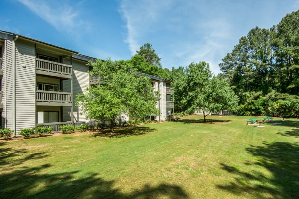 Giant well kept grass area for residents to hang out on at Arbor Crossing Apartments in Lithonia, Georgia
