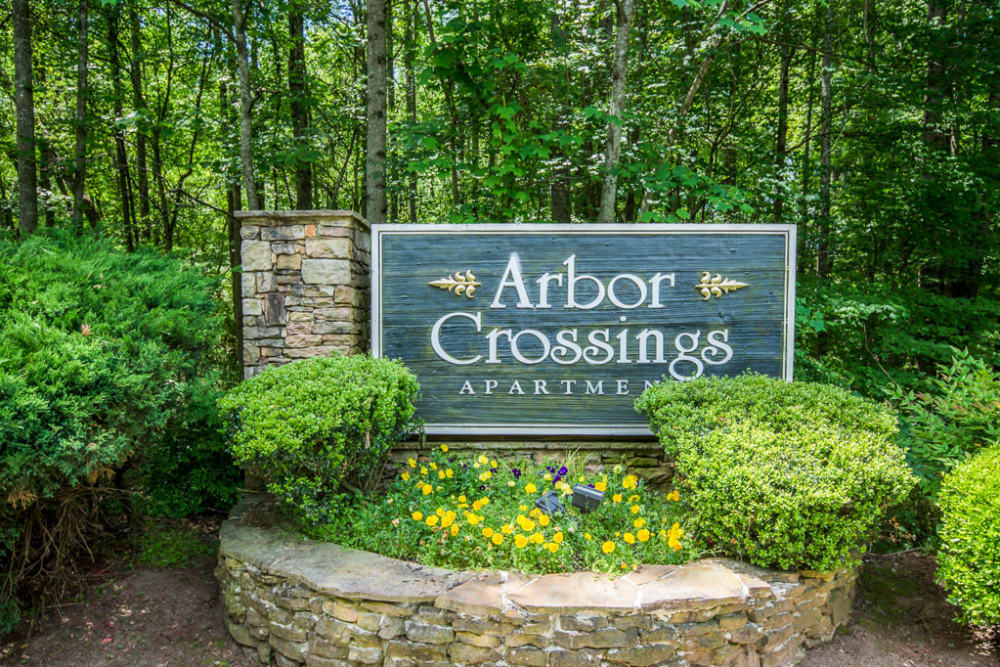 Entrance welcoming sign at Arbor Crossing Apartments in Lithonia, Georgia