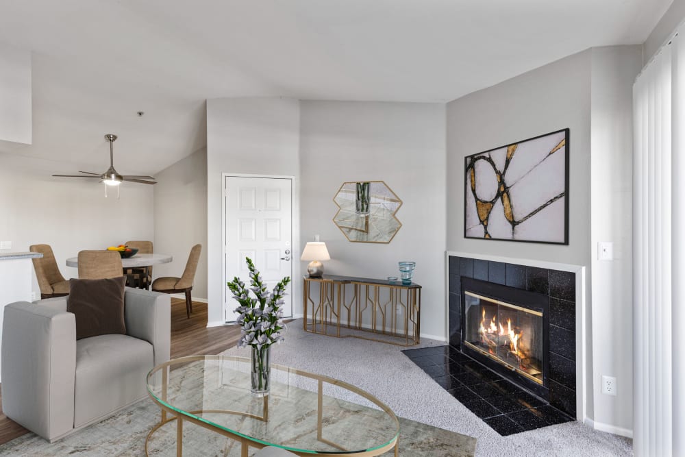 Large living room with fireplace at Sierra Del Oro Apartments in Corona, California