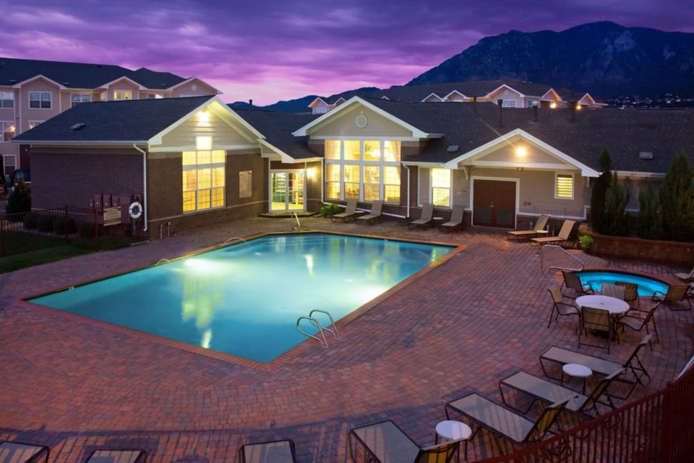 Beautiful pool with lounge chairs at Westmeadow Peaks Apartments in Colorado Springs, Colorado