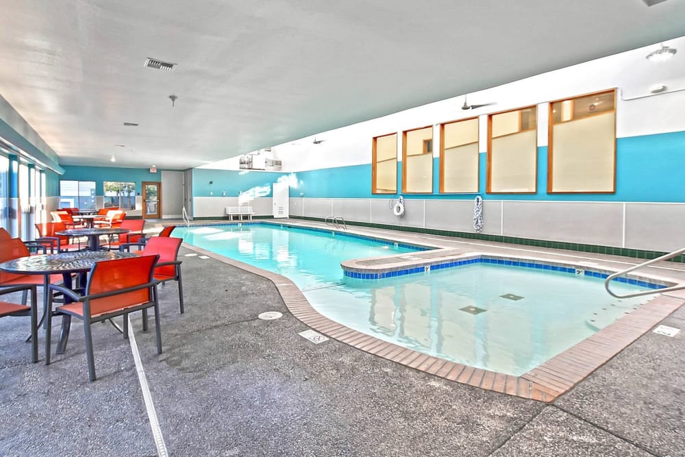 Beautiful swimming pool with lounge seating nearby at The Park at Cooper Point Apartments in Olympia, Washington