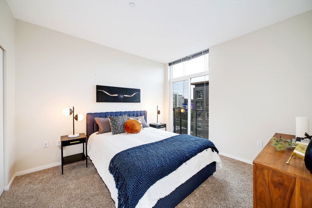 Cozy bedroom in a model home with a nice view from the window at Alley South Lake Union in Seattle, Washington