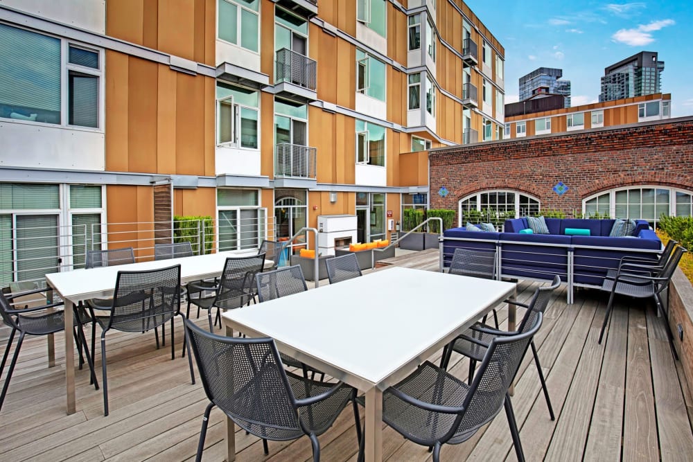 Outdoor seating with tables and chairs to eat, relax, and hang with friends on at Alley South Lake Union in Seattle, Washington