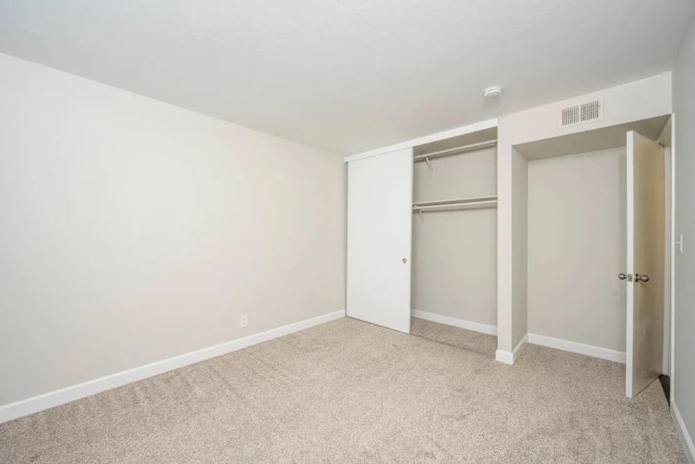 Nice closets in the carpeted bedroom for extra storage space at Hillside Garden in San Mateo, California