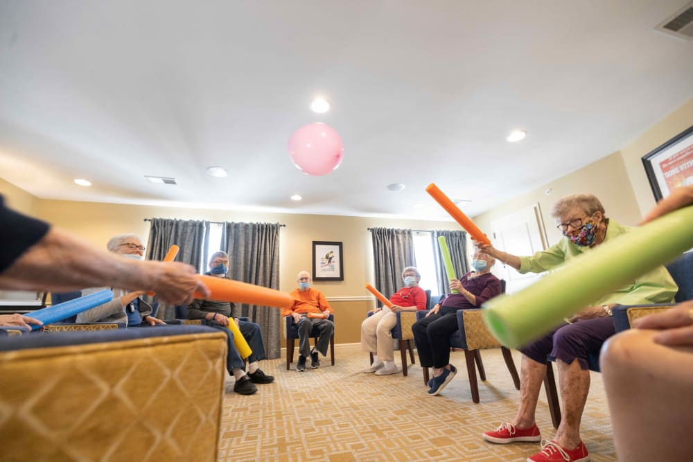 Residents participating in a group fitness activity at The Madison Senior Living in Kansas City, Missouri