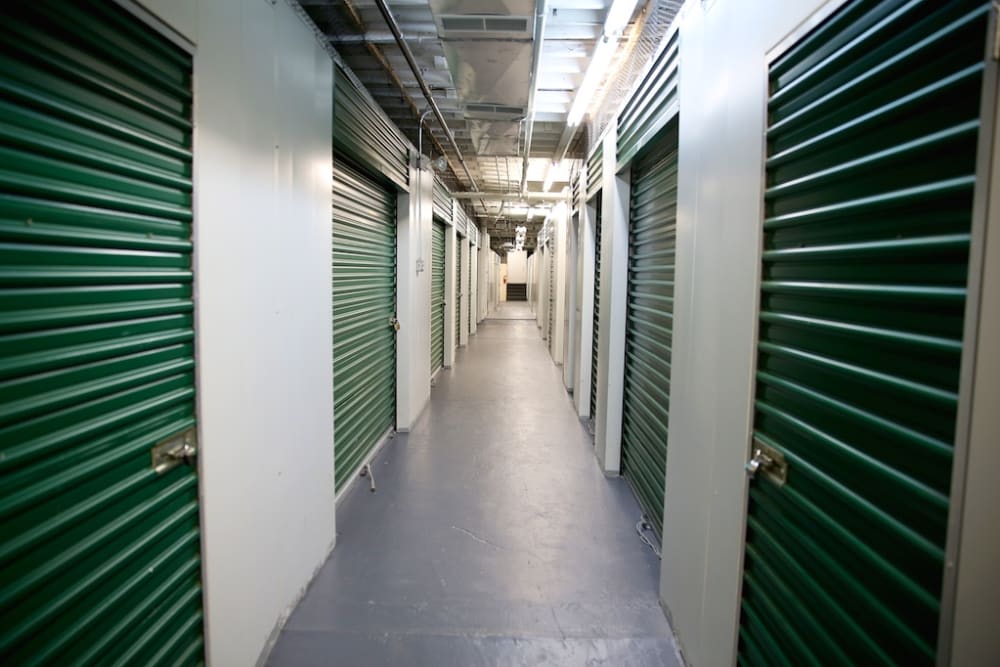 Indoor units with green doors at Advantage Self Storage in Beverly, Massachusetts