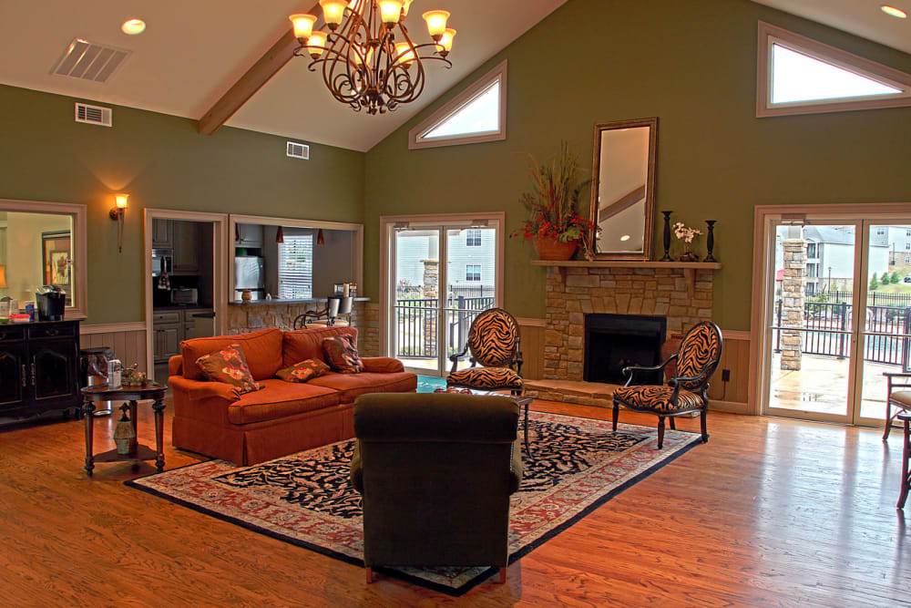 Resident lounge with fireplace at The Gardens on Stadium in Phenix City, Alabama