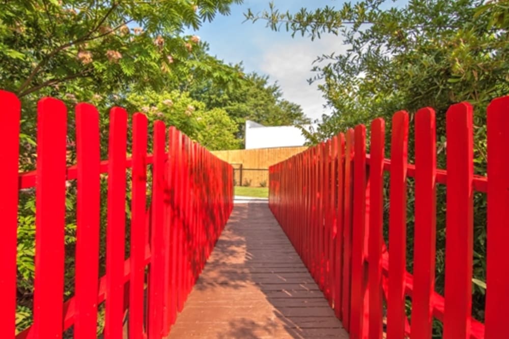 Bridge with bright red wood railings at Gardenbrook Apartments in Columbus, Georgia