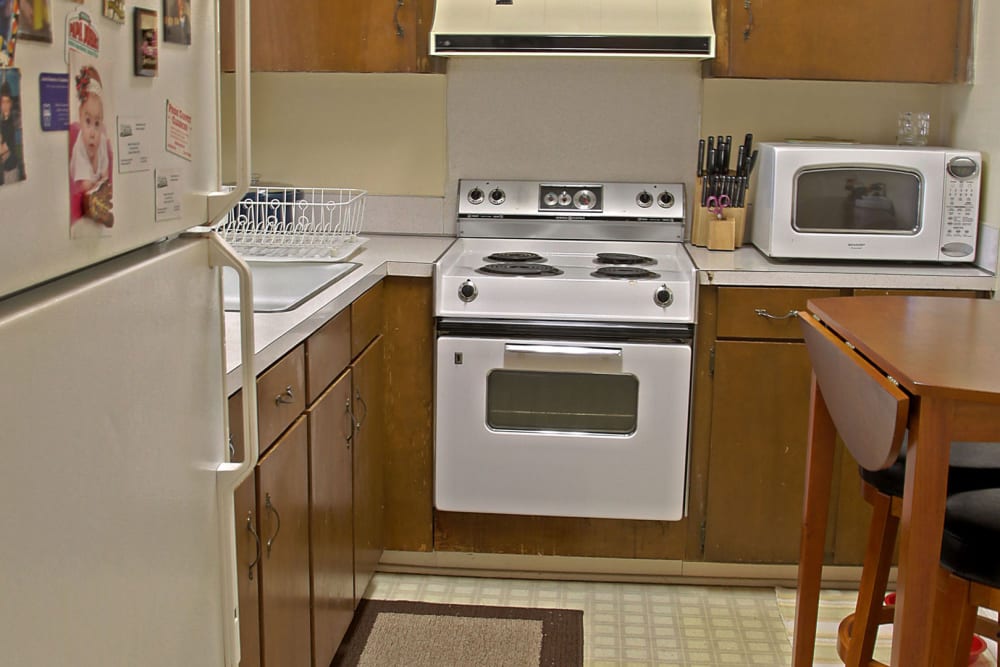 Kitchen with white appliances at RoseHill Apartments, Columbus, Georgia