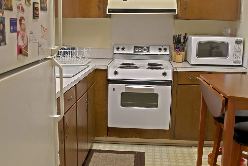 Model kitchen with large wooden cabinets  RoseHill Apartments in Columbus, Georgia