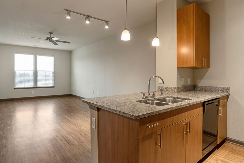 Kitchen and living room at The Addison at South Tryon | Apartments & Townhomes in Charlotte, North Carolina