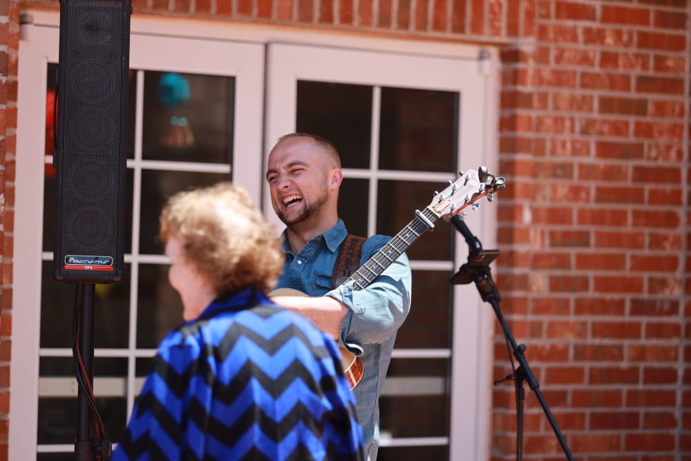 Residents enjoying a live musician at The Westbury Senior Living in Columbia, Missouri